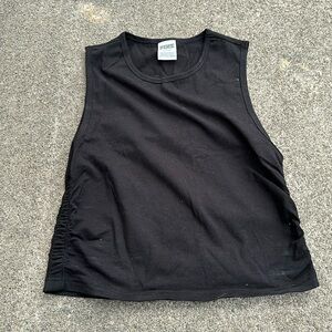 Black size med sleeveless top. It is crop. Never wore but took tags off.